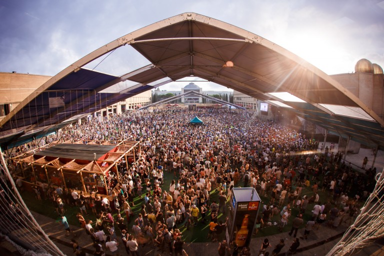 A triangular roof sit above the crowded area of the festival.