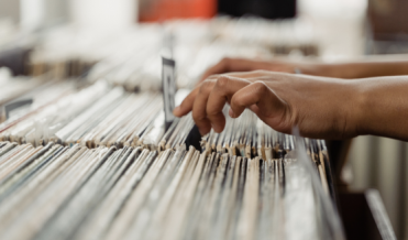 Person's Hand on Vinyl Records