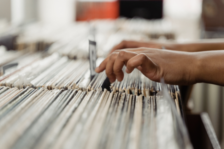 Person's Hand on Vinyl Records